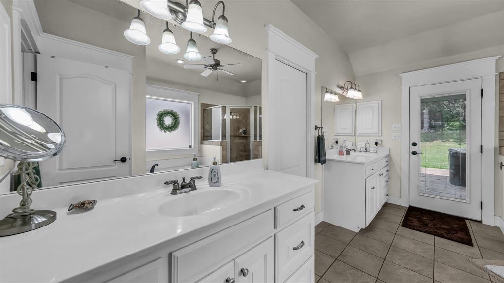 2691 Farm To Market Road 730 North Decatur, TX 76234 - Photo 19 of 36 a spacious bathroom with a double vanity sink a mirror and a shower