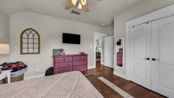 a bedroom with a bed and a flat screen tv