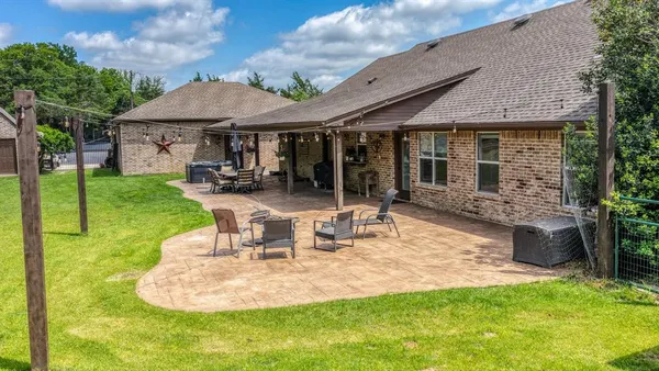 a view of a house with backyard sitting area and garden