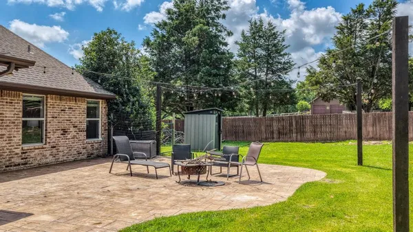 a view of a house with backyard and sitting area