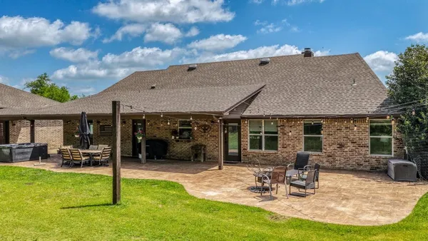 a view of a house with backyard porch and sitting area