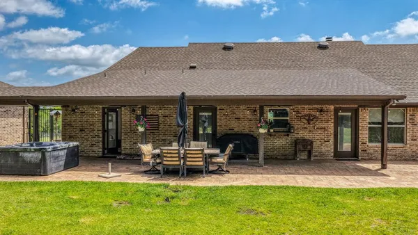 a view of a house with backyard porch and sitting area