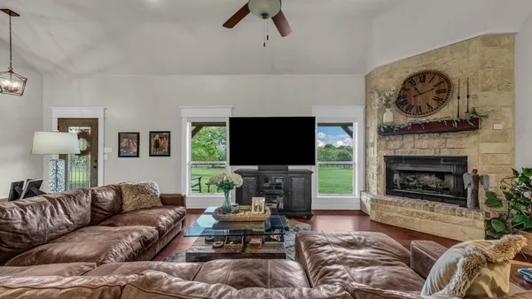 a living room with furniture a flat screen tv and a fireplace