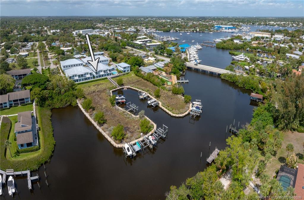 4683 Southeast Manatee Terrace Stuart, FL 34997 - Photo 11 of 45 an aerial view of a house with a lake view