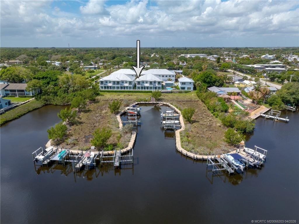 4683 Southeast Manatee Terrace Stuart, FL 34997 - Photo 12 of 45 a view of a lake with a house