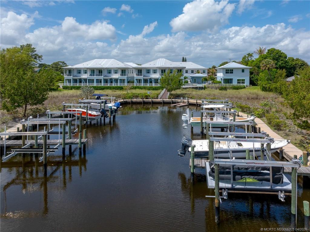 4683 Southeast Manatee Terrace Stuart, FL 34997 - Photo 14 of 45 a view of a lake with a house swimming pool and outdoor space