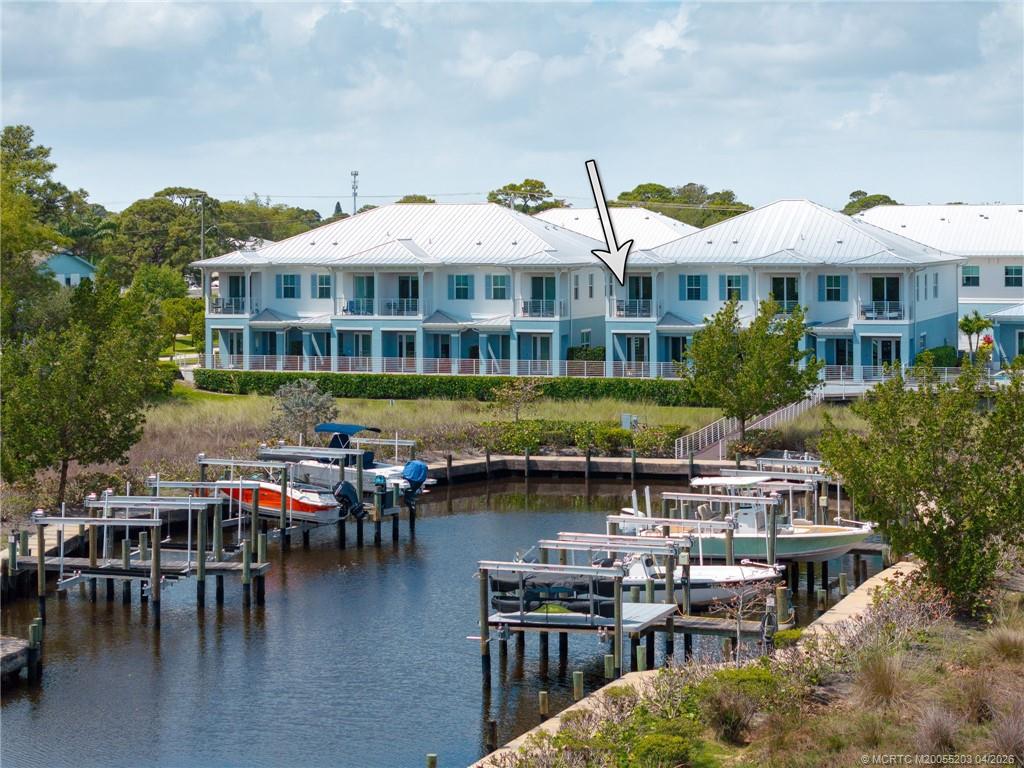 4683 Southeast Manatee Terrace Stuart, FL 34997 - Photo 15 of 45 a front view of a building with lake view and boat