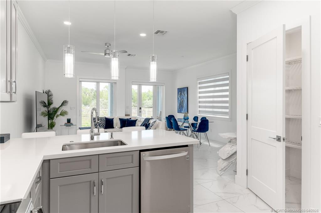 4683 Southeast Manatee Terrace Stuart, FL 34997 - Photo 23 of 45 a kitchen with sink and refrigerator