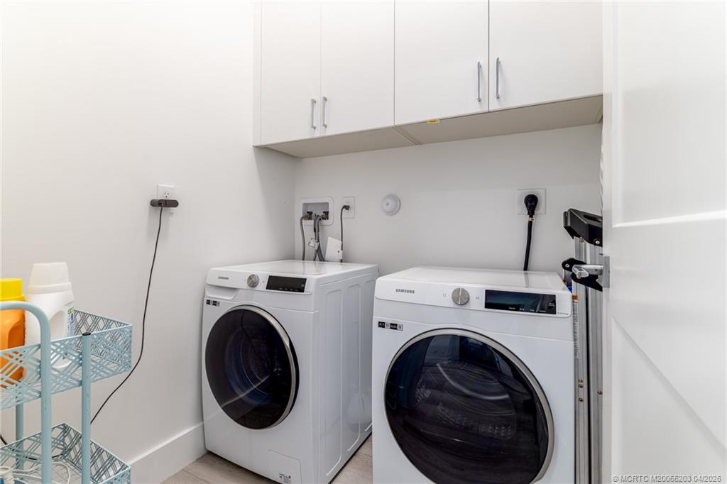 4683 Southeast Manatee Terrace Stuart, FL 34997 - Photo 35 of 45 a utility room with dryer and washer