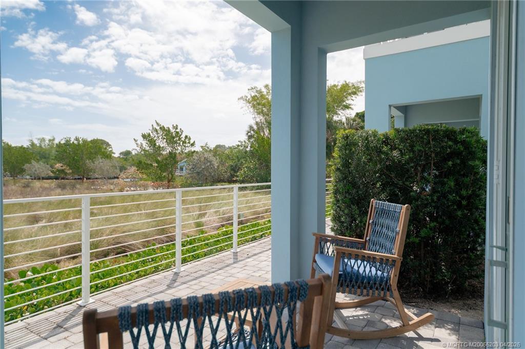 4683 Southeast Manatee Terrace Stuart, FL 34997 - Photo 38 of 45 a view of a chair and table in the balcony