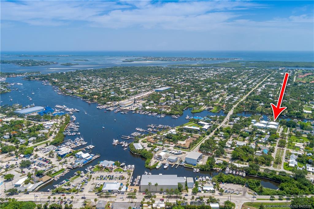 4683 Southeast Manatee Terrace Stuart, FL 34997 - Photo 40 of 45 an aerial view of residential building and lake