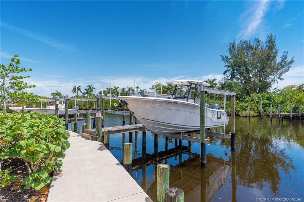 4683 Southeast Manatee Terrace Stuart, FL 34997 - Photo 6 of 45 a balcony with wooden floor and outdoor seating