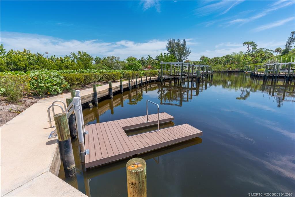 4683 Southeast Manatee Terrace Stuart, FL 34997 - Photo 8 of 45 a view of a lake with couches chairs