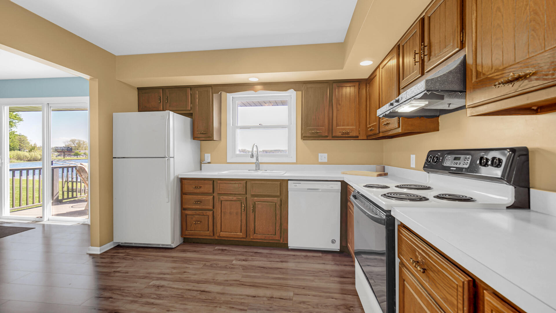 238 West Johnson Road La Porte, IN 46350 - Photo 12 of 35 a kitchen with a refrigerator a stove a sink dishwasher and white cabinets with wooden floor