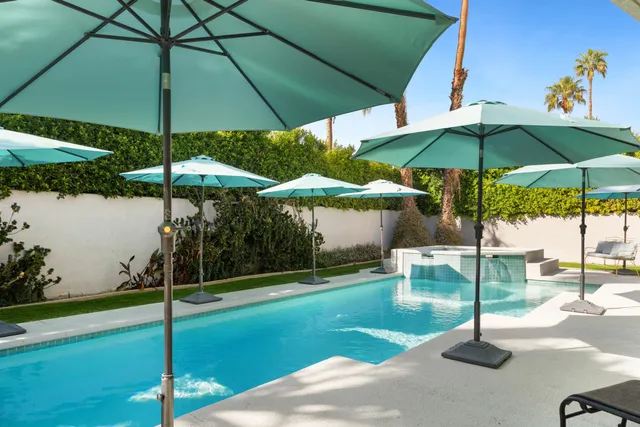 a view of a table and chairs under an umbrella