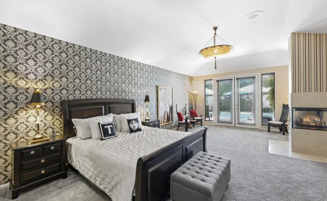 a bedroom with furniture and a fireplace