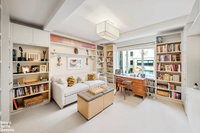 a bedroom with furniture and a book shelf