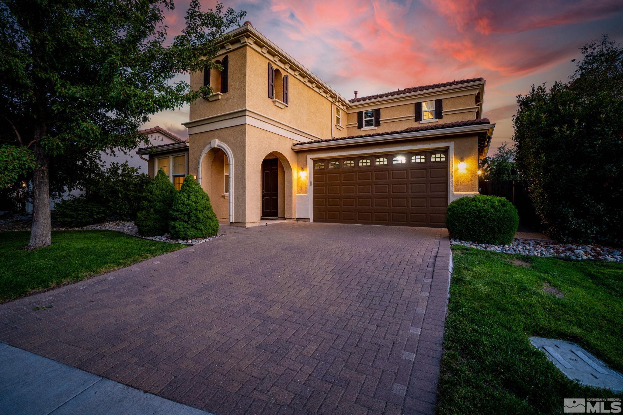 420 Stradella Court Reno, NV 89521 - Photo 1 of 40 a view of a white house with a small yard and plants
