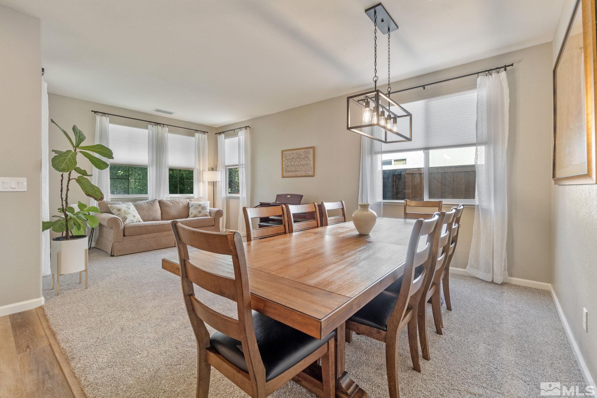 420 Stradella Court Reno, NV 89521 - Photo 18 of 40 a view of a dining room with furniture window and wooden floor