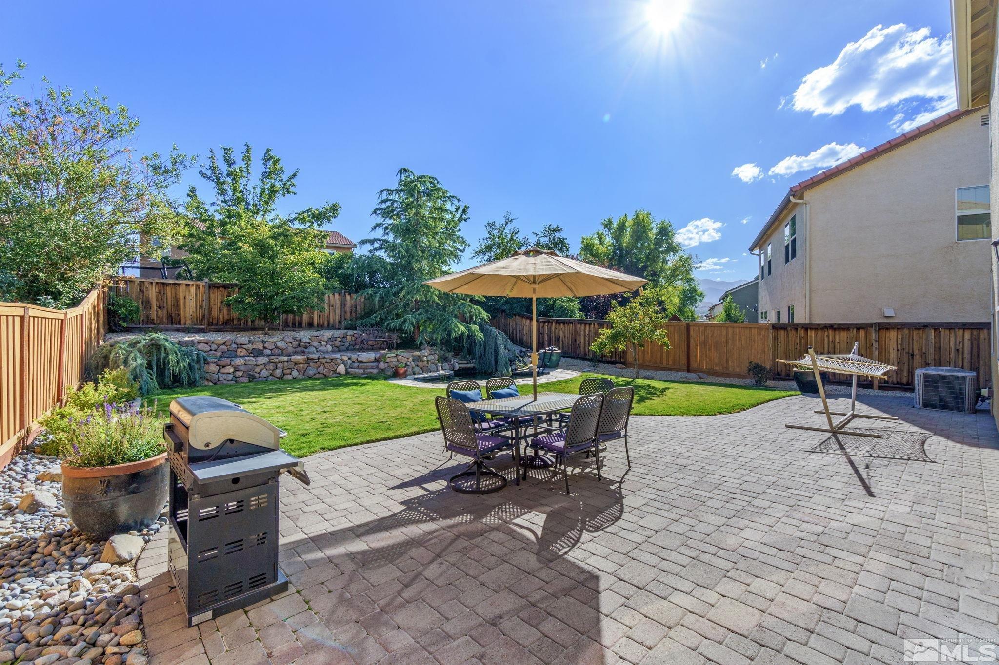 420 Stradella Court Reno, NV 89521 - Photo 27 of 40 a view of a table and chairs under an umbrella