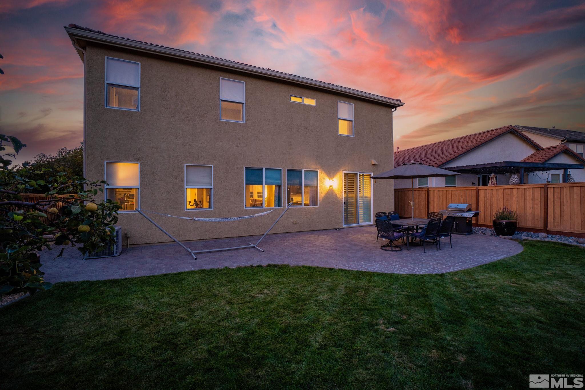 420 Stradella Court Reno, NV 89521 - Photo 3 of 40 a view of a backyard with table and chairs under an umbrella