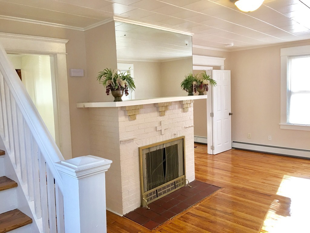 11 Bushwick Place Springfield, MA 01109 - Photo 4 of 13 a view of a livingroom with wooden floor and a fireplace