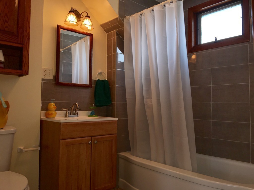 11 Bushwick Place Springfield, MA 01109 - Photo 9 of 13 a bathroom with a sink a toilet a mirror and shower
