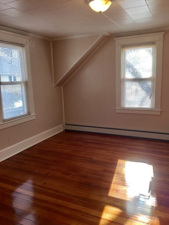 11 Bushwick Place Springfield, MA 01109 - Photo 10 of 13 a view of an empty room with wooden floor and a window