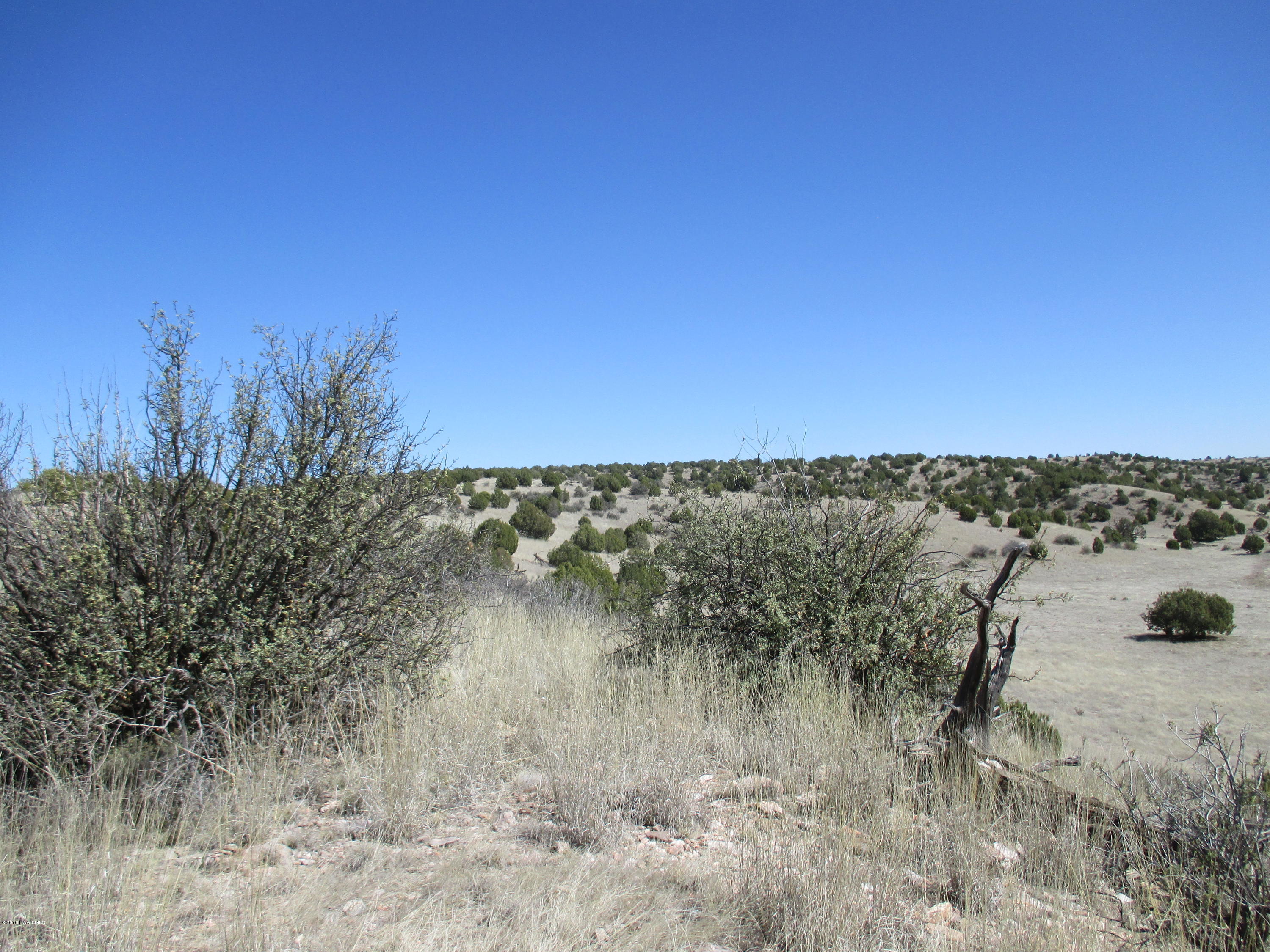17801 Crossroads Ranch Road Prescott, AZ 86305 - Photo 10 of 13 a view of a lake with a house in background