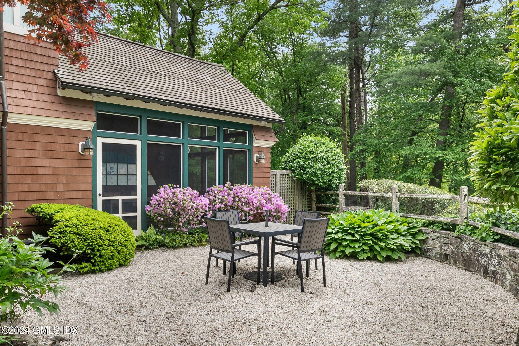 306 Stanwich Road Greenwich, CT 06830 - Photo 30 of 87 a view of a table and chair and table in the garden