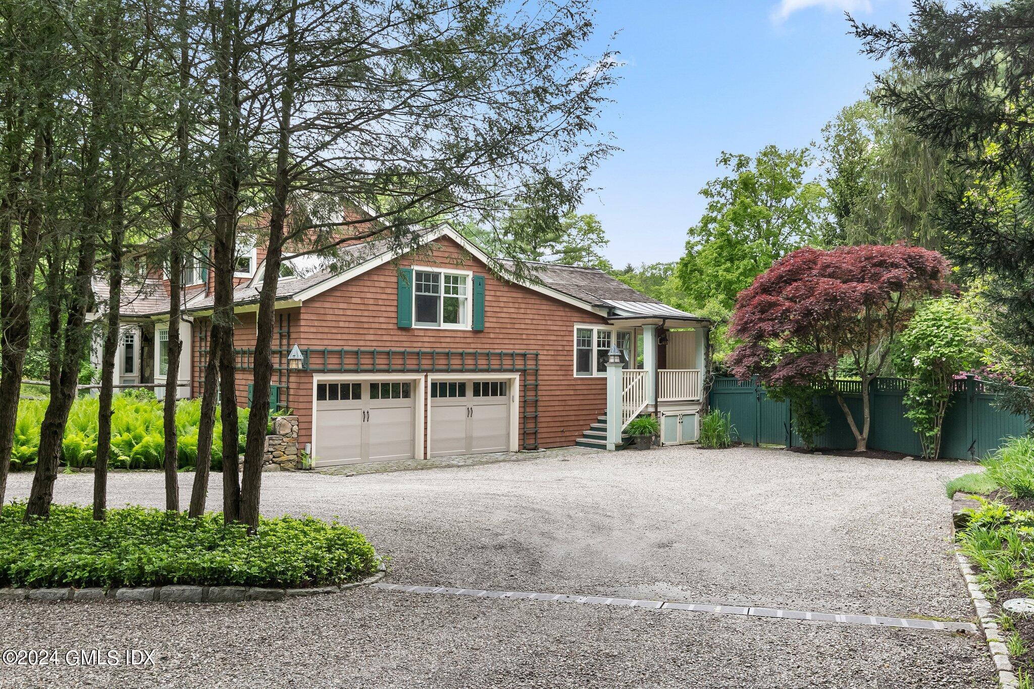 306 Stanwich Road Greenwich, CT 06830 - Photo 40 of 87 a front view of a house with a yard and potted plants