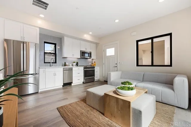 a kitchen with stainless steel appliances granite countertop a refrigerator sink and stove