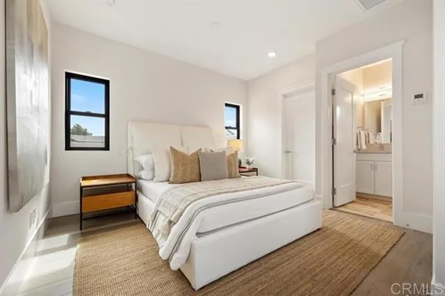 a bedroom with a bed and a painting on the wall