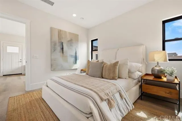 a bedroom with a bed and lamp