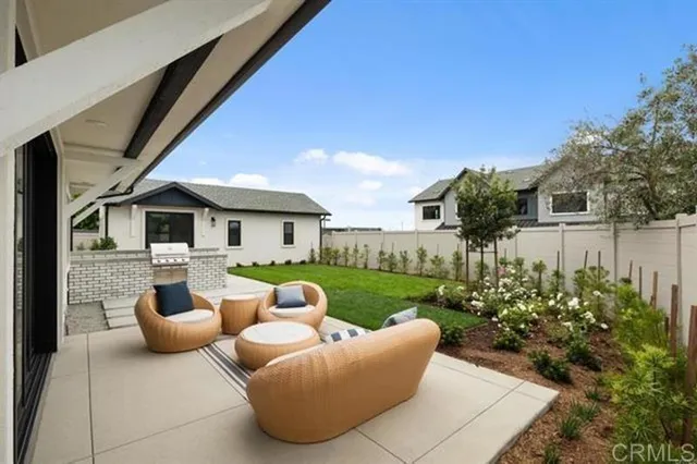 a view of a patio with couches chairs potted plants and sky view