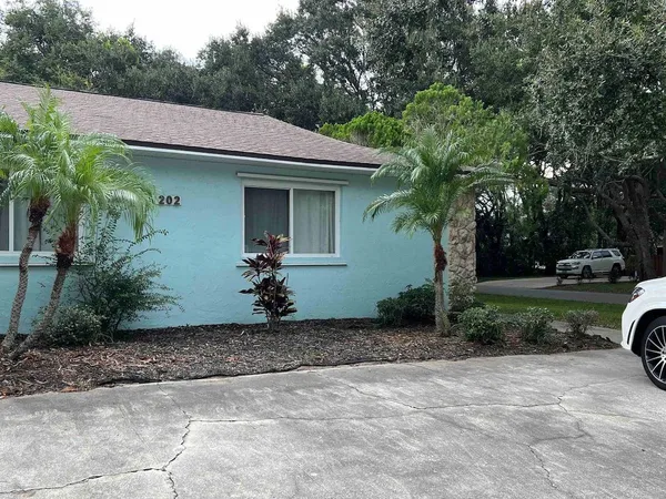 a front view of a house with a garden