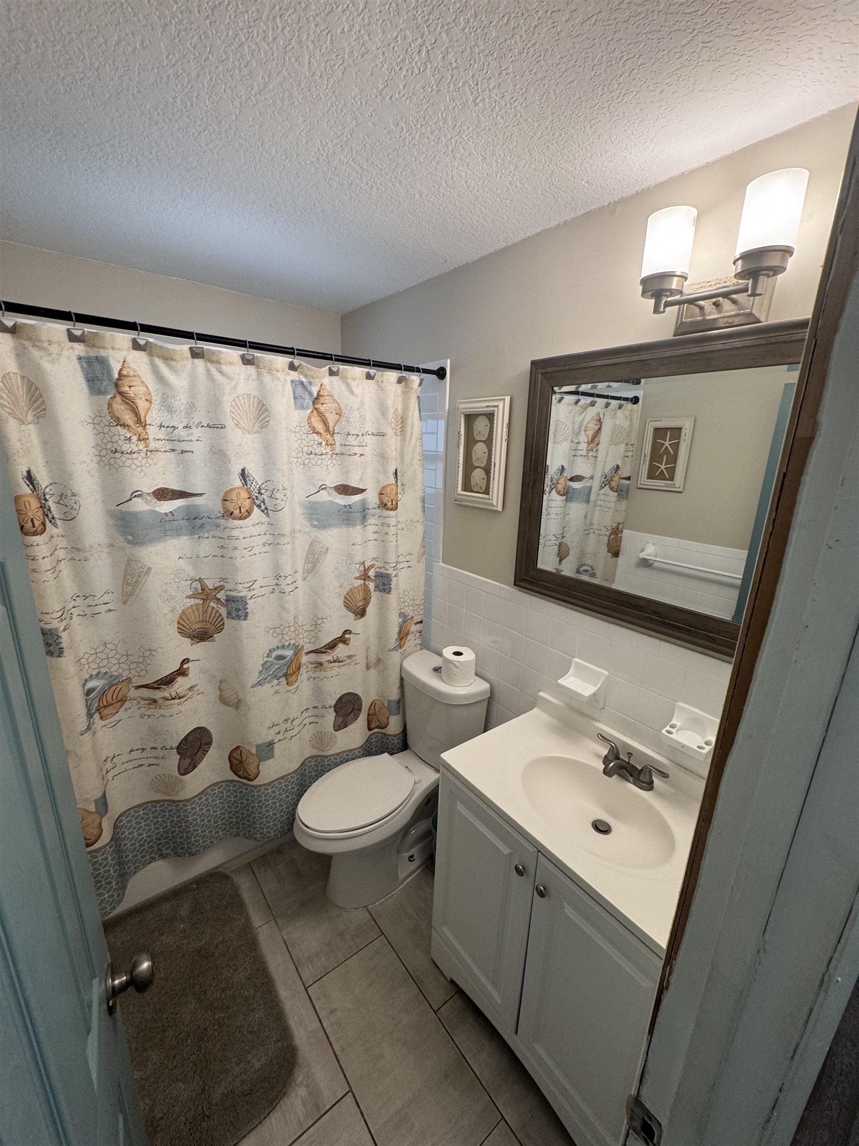 202 E Street, Unit A St. Augustine, FL 32080 - Photo 12 of 22 a bathroom with a sink toilet and shower