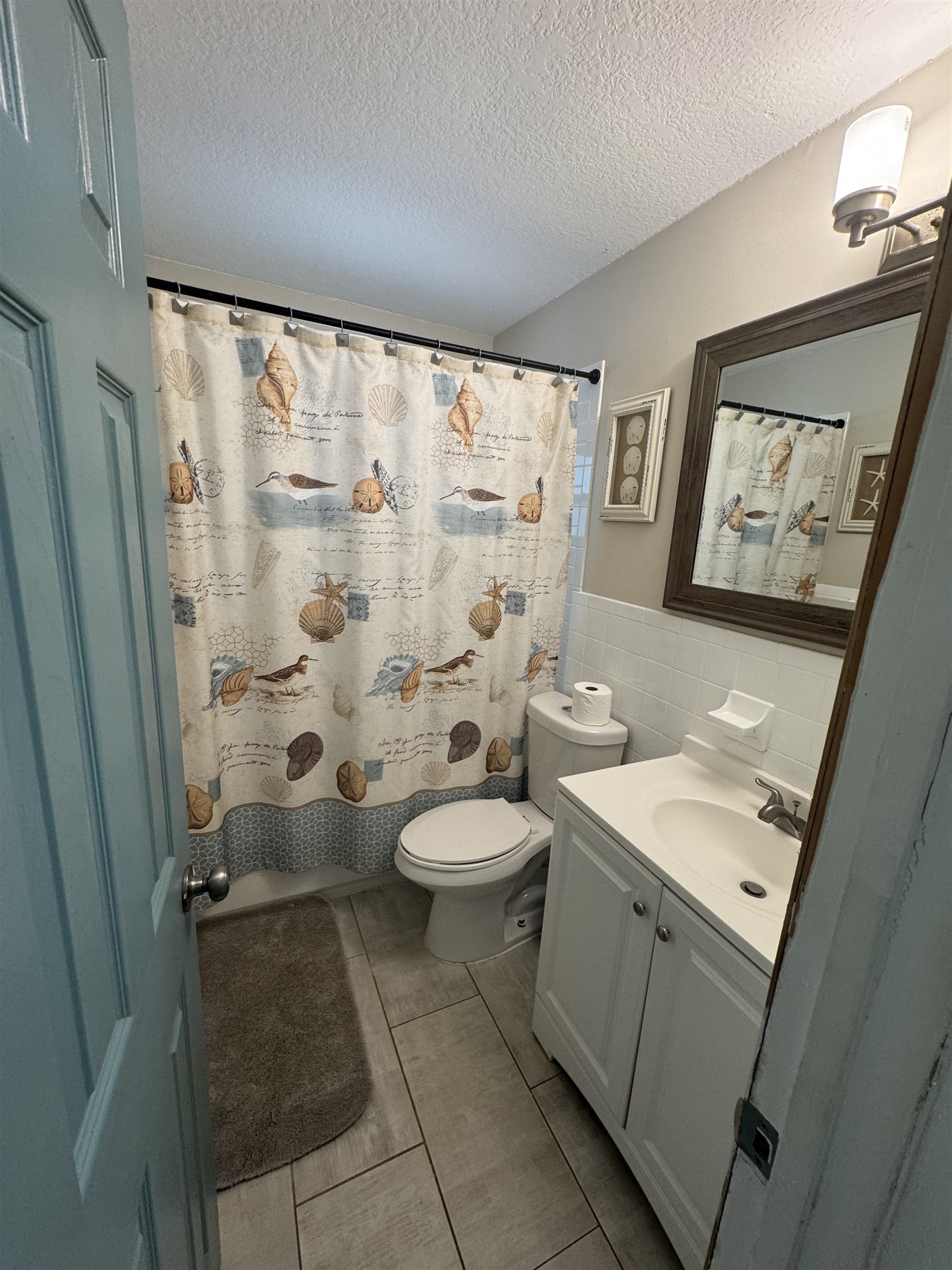 202 E Street, Unit A St. Augustine, FL 32080 - Photo 13 of 22 a bathroom with a granite countertop sink toilet and shower