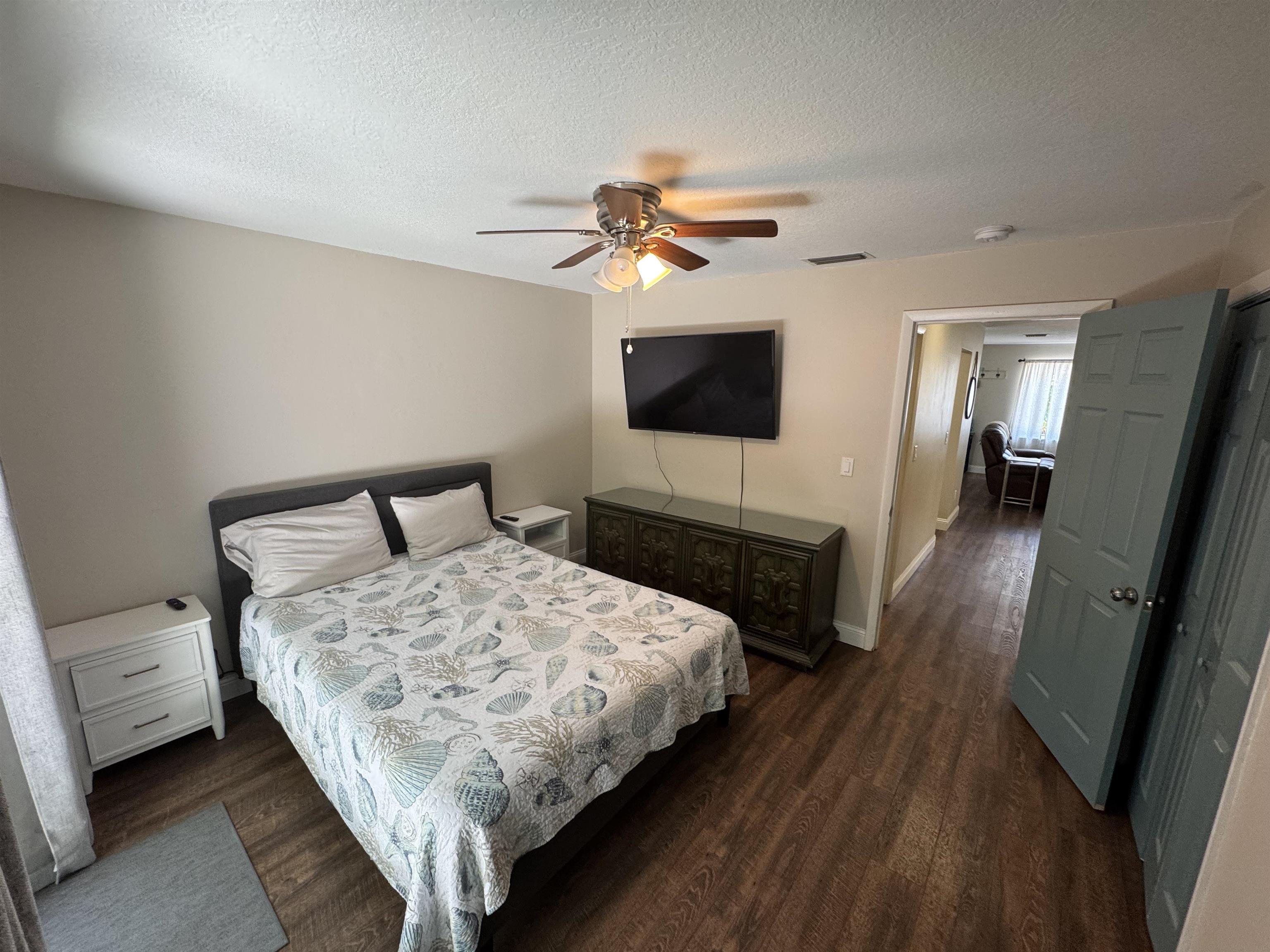 202 E Street, Unit A St. Augustine, FL 32080 - Photo 15 of 22 a bedroom with a bed and a flat screen tv
