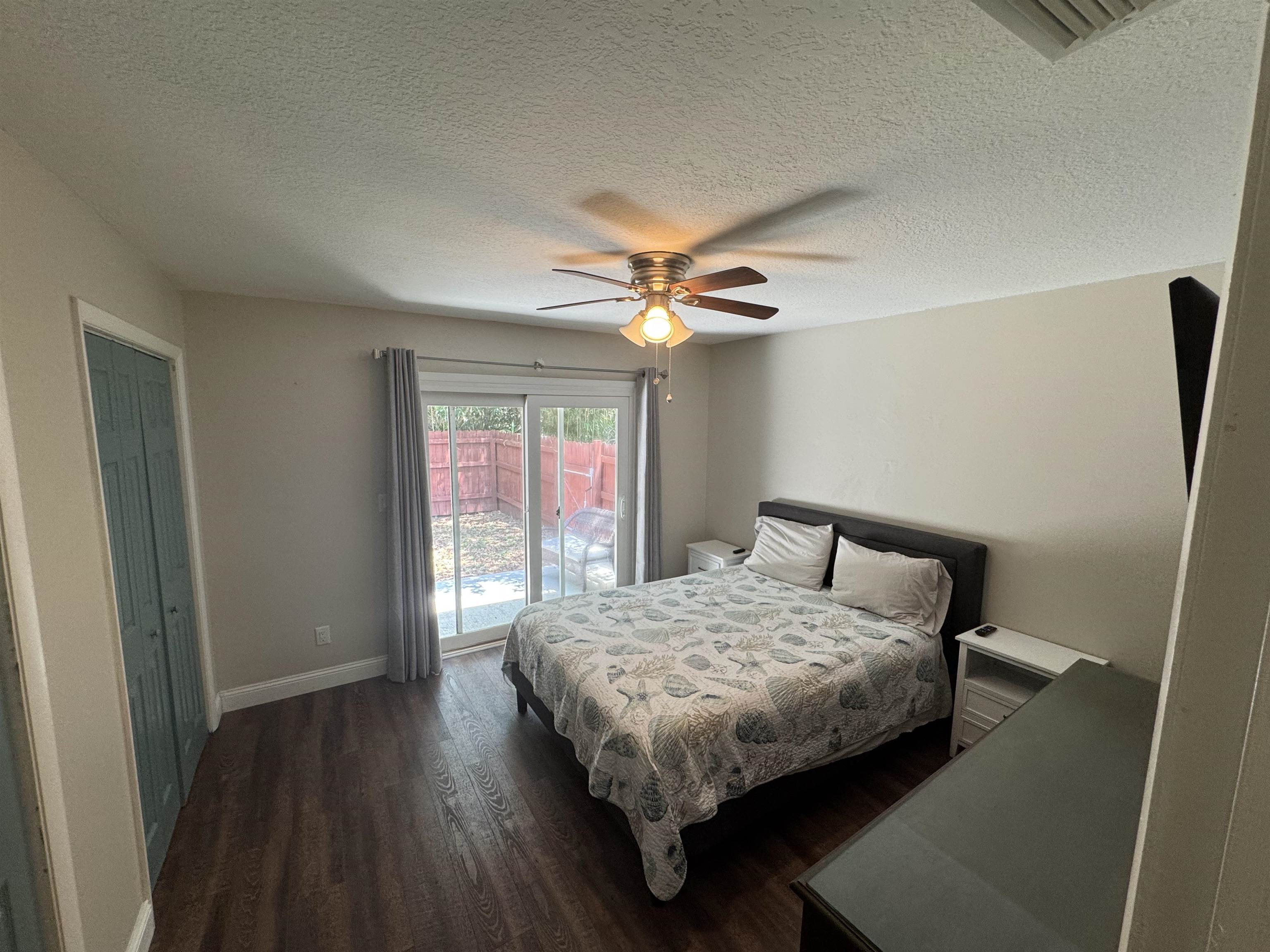 202 E Street, Unit A St. Augustine, FL 32080 - Photo 16 of 22 a bedroom with a bed and a chandelier