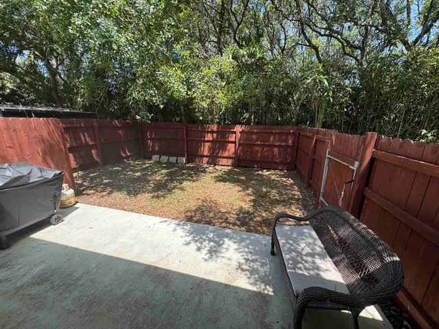 a view of a backyard with sitting area