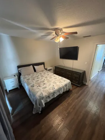 a bedroom with a bed and a flat screen tv
