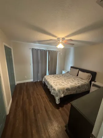 a bedroom with a bed and a mirror