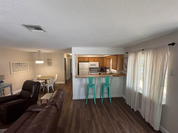 a view of hallway with furniture and wooden floor