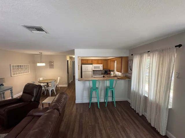 a view of hallway with furniture and wooden floor