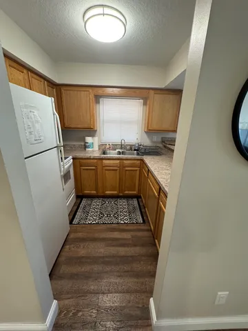 a kitchen with sink refrigerator and stove