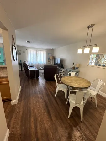a view of a dining room with furniture window and wooden floor