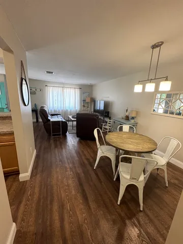 a view of a dining room with furniture window and wooden floor