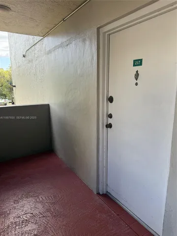 an empty room with wooden floor and closet