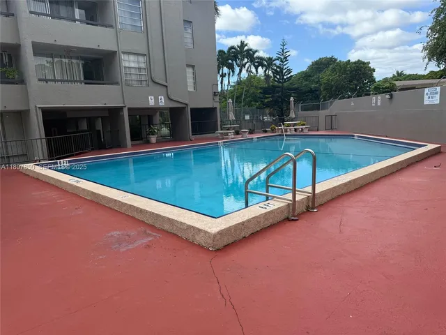 a kitchen with stainless steel appliances a sink a stove top oven a counter space and cabinets